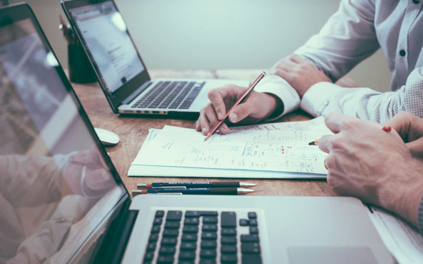 Business automation planning on laptops and paper notes